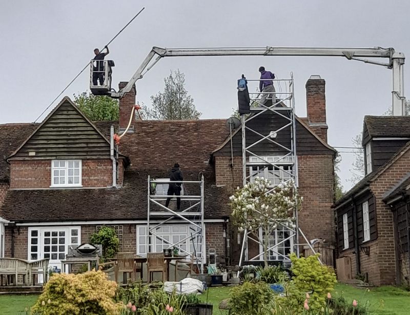 The Moss Cleaners using cherry picker and scaffolding to clean roof safely and professionally in North Baddesley, Hampshire